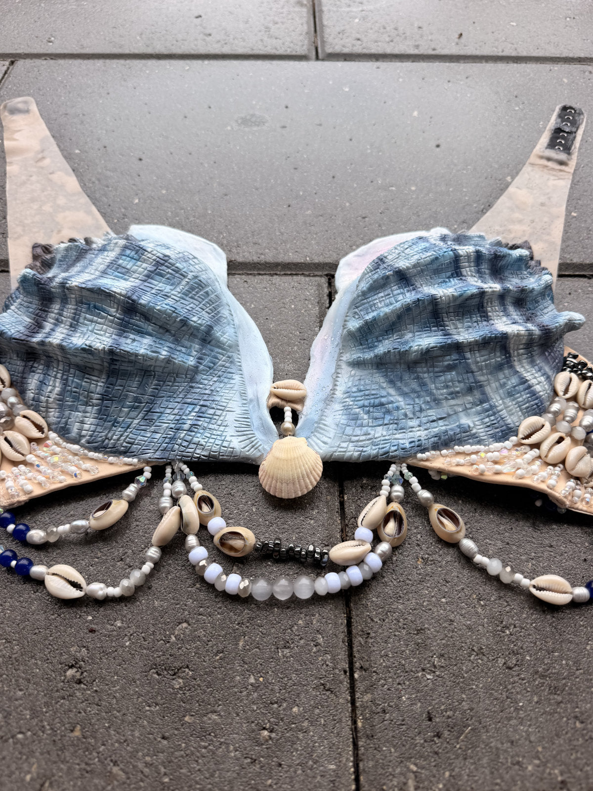 Blue Siren silicone mermaid top laid flat showing both sculpted shell cups and decorative bead strands